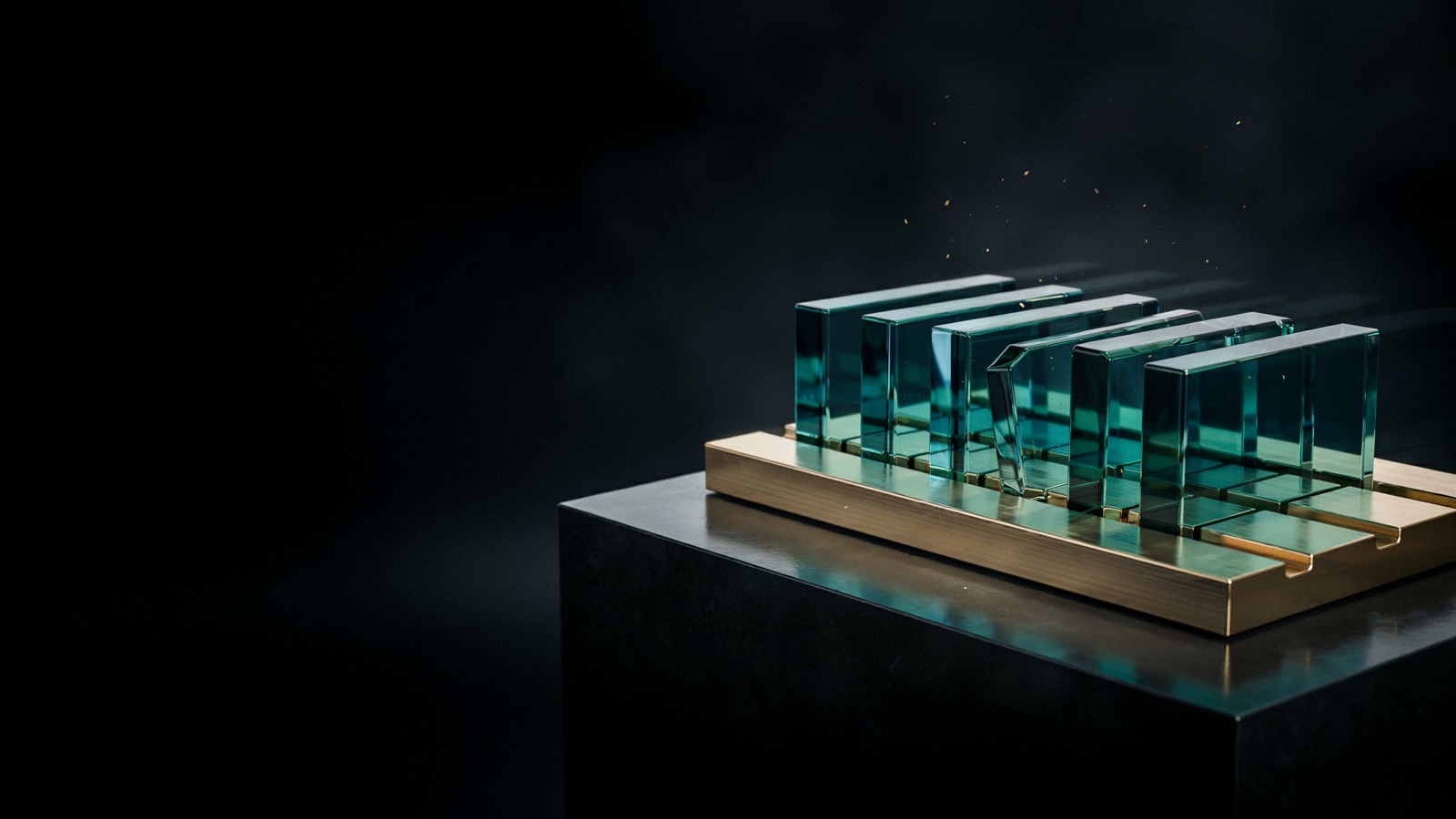 Six teal glass modules seated in a gold frame on an obsidian plinth